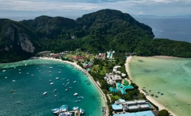 A breathtaking aerial shot of a tropical island with lush greenery and turquoise waters, perfect for travel lovers.